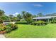 This attractive home features a metal roof, lush landscaping, and a well-maintained front lawn with a mailbox at 2321 Milford Cir, Sarasota, FL 34239