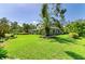 This attractive home features a metal roof, lush landscaping, and a well-maintained front lawn at 2321 Milford Cir, Sarasota, FL 34239