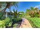 A brick walkway leads to this beautiful home with mature landscaping at 2321 Milford Cir, Sarasota, FL 34239