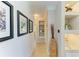 Bright hallway featuring decorative shelving, stylish decor, and beautiful artwork on the shiplap wall at 2321 Milford Cir, Sarasota, FL 34239