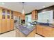 Lovely kitchen with wood cabinetry, stainless steel appliances, and a functional center island at 2321 Milford Cir, Sarasota, FL 34239