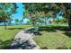 Scenic park view with a tranquil walking path and inviting benches beneath shady trees by the bay at 2321 Milford Cir, Sarasota, FL 34239