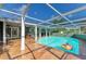 Inviting pool area featuring a covered patio, poolside bar, and stylish tiled deck at 2321 Milford Cir, Sarasota, FL 34239