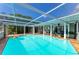 Beautiful screened pool area with a tiled deck, poolside bar, and plenty of space for relaxation at 2321 Milford Cir, Sarasota, FL 34239