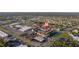 Aerial view of condo community surrounded by local businesses, ample parking, and mature landscaping at 2395 Harbor Blvd # 314, Port Charlotte, FL 33952