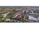 Aerial view shows the condos surrounded by shopping centers, green spaces, and easy access to roads at 2395 Harbor Blvd # 314, Port Charlotte, FL 33952