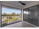 Enclosed balcony featuring a ceiling fan and a view of the manicured lawn and neighborhood at 2395 Harbor Blvd # 314, Port Charlotte, FL 33952