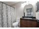 Bathroom with modern vanity and sink plus a floral shower curtain for a charming touch at 2395 Harbor Blvd # 314, Port Charlotte, FL 33952
