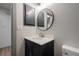 Clean bathroom featuring a modern sink, round mirror, and minimalist design elements at 2395 Harbor Blvd # 314, Port Charlotte, FL 33952