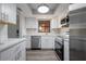 Renovated kitchen featuring stainless steel appliances, sleek cabinetry and hardwood floors at 2395 Harbor Blvd # 314, Port Charlotte, FL 33952