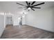 Open-concept living room with sleek wood floors and views into the modern kitchen at 2395 Harbor Blvd # 314, Port Charlotte, FL 33952