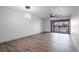 Spacious living room showcasing ceiling fan, lighting fixture, and sliding glass doors to the balcony at 2395 Harbor Blvd # 314, Port Charlotte, FL 33952