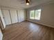 Bedroom featuring a ceiling fan, a large window, and roomy closet space at 2613 Pine Lake Ter # C, Sarasota, FL 34237