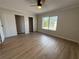 Bedroom featuring a ceiling fan, a large window, and generous closet space at 2613 Pine Lake Ter # C, Sarasota, FL 34237