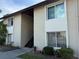 Exterior of the two-story building with well-maintained landscaping and visible unit number at 2613 Pine Lake Ter # C, Sarasota, FL 34237