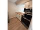 The kitchen offers stainless steel appliances, wooden countertops, and white cabinets at 2613 Pine Lake Ter # C, Sarasota, FL 34237