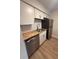 The kitchen has wooden countertops, stainless steel appliances, and white cabinets at 2613 Pine Lake Ter # C, Sarasota, FL 34237