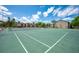 Well-maintained community tennis court with clear markings and surrounding trees at 2613 Pine Lake Ter # C, Sarasota, FL 34237