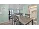 Open-concept floor plan with a dining area featuring a gray wooden table with seating for six at 2901 26Th W St # 204, Bradenton, FL 34205