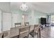 Dining room with a table for six next to a living room with a TV and a patio door at 2901 26Th W St # 204, Bradenton, FL 34205