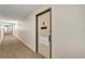 Hallway leading to a condo with a decorated door at 2901 26Th W St # 204, Bradenton, FL 34205
