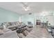 A well-decorated living room leads to a dining room and is furnished with a comfortable gray sofa at 2901 26Th W St # 204, Bradenton, FL 34205