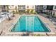 Beautiful community pool surrounded by lounge chairs and lush landscaping at 2901 26Th W St # 204, Bradenton, FL 34205