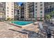 A swimming pool outside a condo building features a brick deck and patio seating at 2901 26Th W St # 204, Bradenton, FL 34205