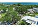 Aerial shot overlooking the house with mature trees, a water view, and nearby local community at 3307 Miami Pl, Bradenton, FL 34207