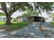 Charming single-story home featuring a covered porch and driveway under a large tree canopy at 3307 Miami Pl, Bradenton, FL 34207