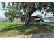 Single-story home with shade trees, a covered driveway, and landscaped front yard at 3307 Miami Pl, Bradenton, FL 34207