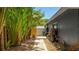 A lovely view of the backyard along the side of the house, with an exterior shed and lush landscaping at 3525 Riviera Dr, Sarasota, FL 34232