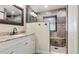 This bathroom boasts modern fixtures, a tiled shower, and granite counters at 3525 Riviera Dr, Sarasota, FL 34232
