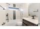 Bathroom featuring modern fixtures, a shower and tub, and marble accents at 3525 Riviera Dr, Sarasota, FL 34232