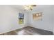 This bedroom is brightly lit, featuring a ceiling fan and wood-look floors at 3525 Riviera Dr, Sarasota, FL 34232