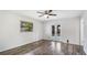 Bedroom showcasing wood-look floors, a window, and direct patio access at 3525 Riviera Dr, Sarasota, FL 34232
