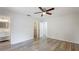 This bedroom features wood-look floors and access to a full bathroom at 3525 Riviera Dr, Sarasota, FL 34232