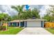 Lovely single-story home with lush green lawn and well-maintained landscaping at 3525 Riviera Dr, Sarasota, FL 34232
