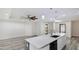 Open concept kitchen with large island and easy access to the living room at 3525 Riviera Dr, Sarasota, FL 34232
