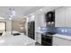 Modern kitchen with stainless steel appliances, large island, and pendant lighting at 3525 Riviera Dr, Sarasota, FL 34232