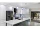 Modern kitchen with sleek white cabinetry, stainless steel appliances, and a large island at 3525 Riviera Dr, Sarasota, FL 34232