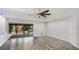 Spacious living area with slider access to a lanai and stylish modern flooring at 3525 Riviera Dr, Sarasota, FL 34232