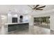 Bright and airy living space with access to the lanai, open to modern kitchen, and stylish flooring at 3525 Riviera Dr, Sarasota, FL 34232