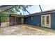 View of the brick patio and covered lanai, ideal for outdoor entertaining and relaxation at 3525 Riviera Dr, Sarasota, FL 34232