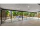 Enclosed patio offering expansive views of the fenced backyard at 3525 Riviera Dr, Sarasota, FL 34232