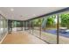 Relax in this screened-in sunroom with brick-paved patio and views of the backyard's lush landscaping and picnic area at 3525 Riviera Dr, Sarasota, FL 34232