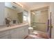 Bathroom featuring a shower with glass doors, vanity, and large mirror at 3615 Puerta Ct # 8516, Sarasota, FL 34232