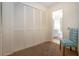Bright bedroom with large closet and chair, leading to a bathroom at 3615 Puerta Ct # 8516, Sarasota, FL 34232