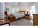 Cozy bedroom with neutral carpet, window, ceiling fan, and ample natural light at 3615 Puerta Ct # 8516, Sarasota, FL 34232