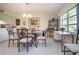 Bright dining room featuring tile floors, a glass table set, and a large window at 3615 Puerta Ct # 8516, Sarasota, FL 34232